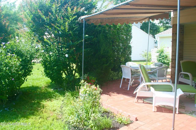 a view of backyard with a patio