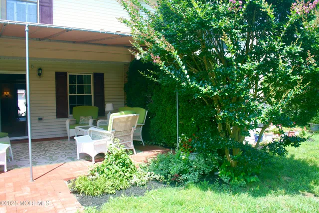 a view of a chair and tables in the back yard of the house