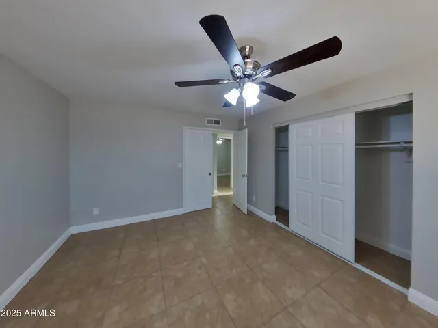 a kitchen with granite countertop white cabinets sink and window