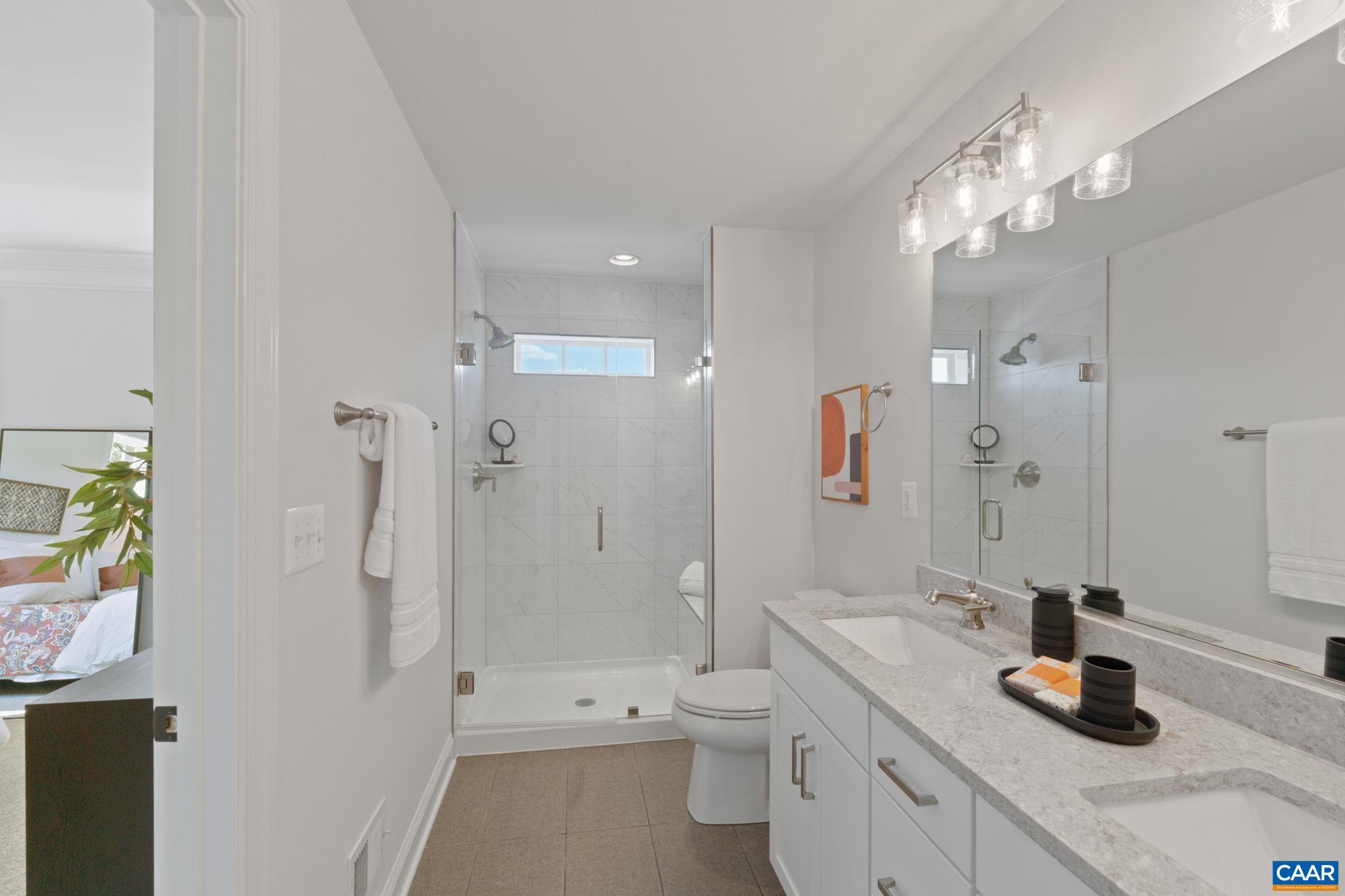 2215 Woodburn Road Charlottesville, VA 22901 - Photo 18 of 32 a bathroom with a double vanity sink toilet and shower