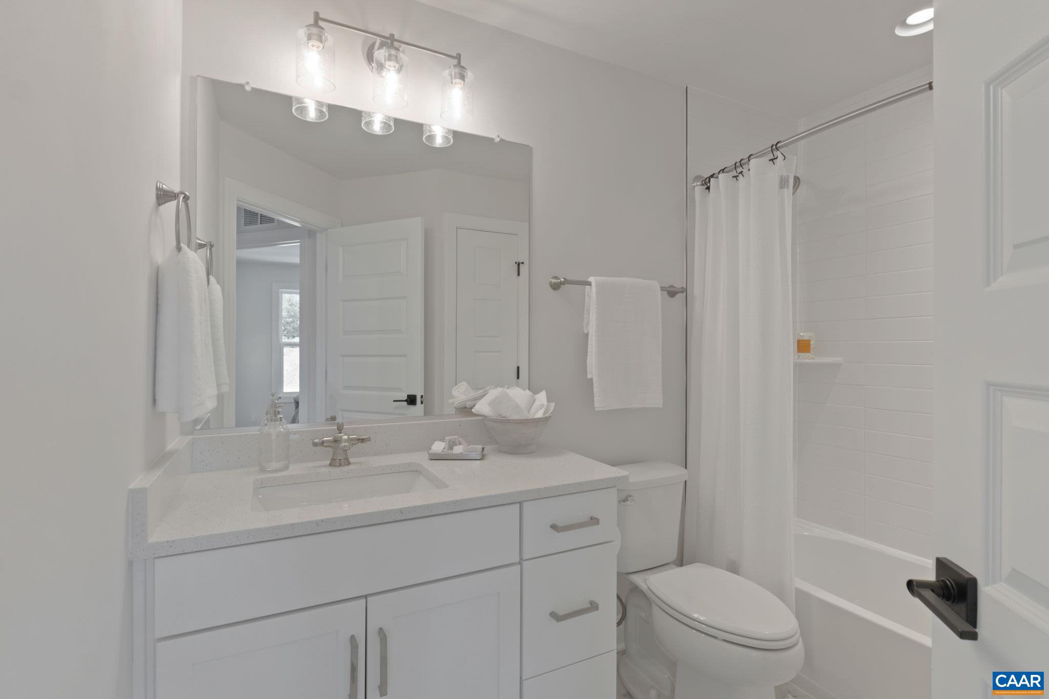 2215 Woodburn Road Charlottesville, VA 22901 - Photo 23 of 32 a bathroom with a sink toilet double vanity and shower