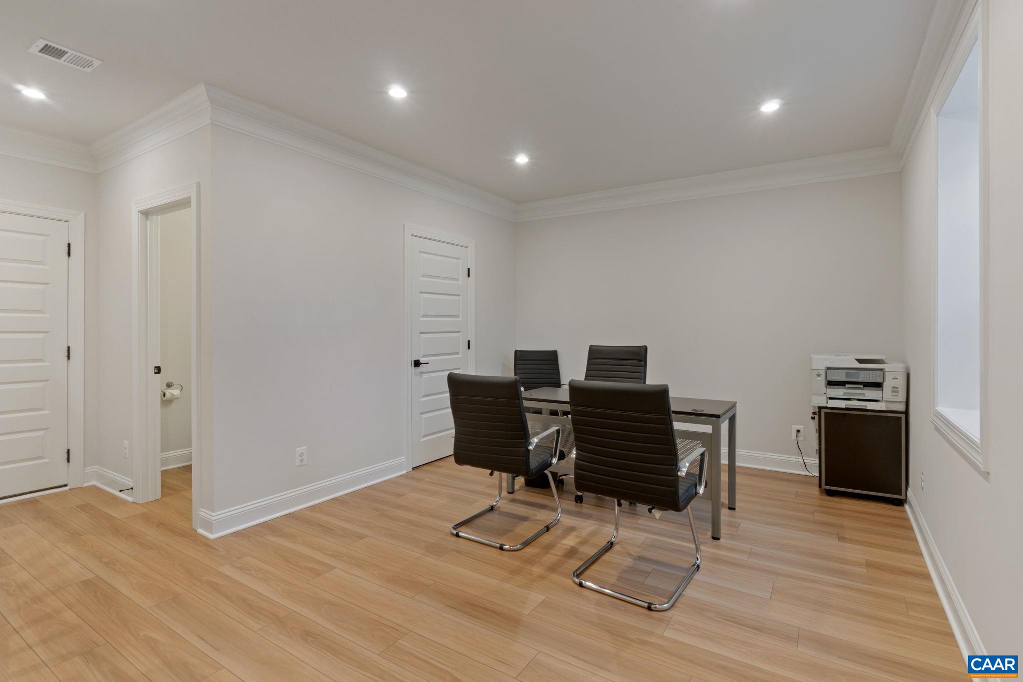 2215 Woodburn Road Charlottesville, VA 22901 - Photo 26 of 32 a view of a workspace with furniture and wooden floor