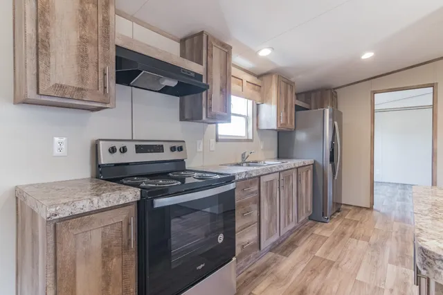 a view of a refrigerator in kitchen and wooden floor