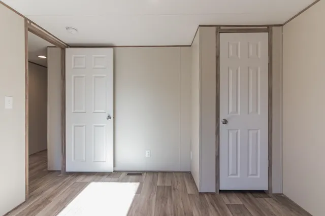 a bathroom with a granite countertop sink a mirror and a bathtub