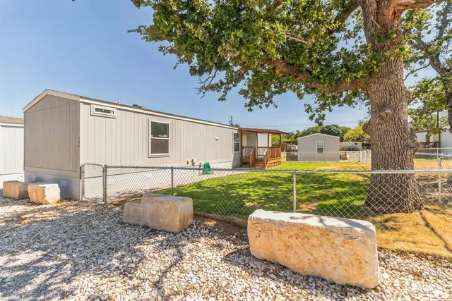 a swimming pool with outdoor seating and yard