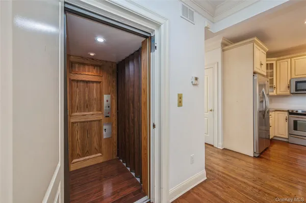 a view of hallway with wooden floor