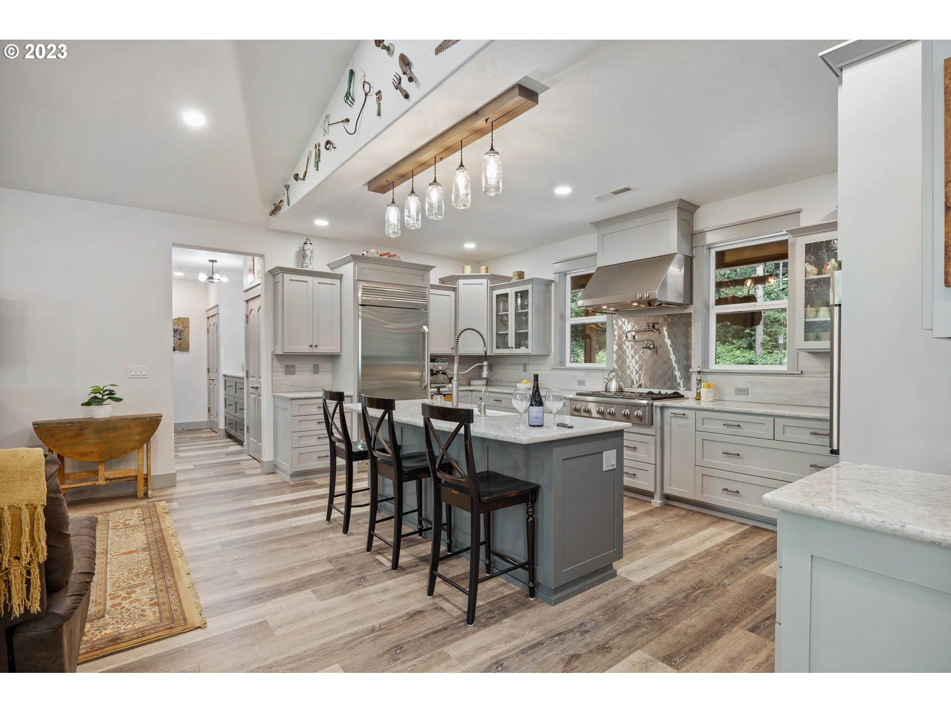 37693 Hills Creek Road Springfield, OR 97478 - Photo 11 of 48 a kitchen with stainless steel appliances kitchen island granite countertop a table chairs and a refrigerator