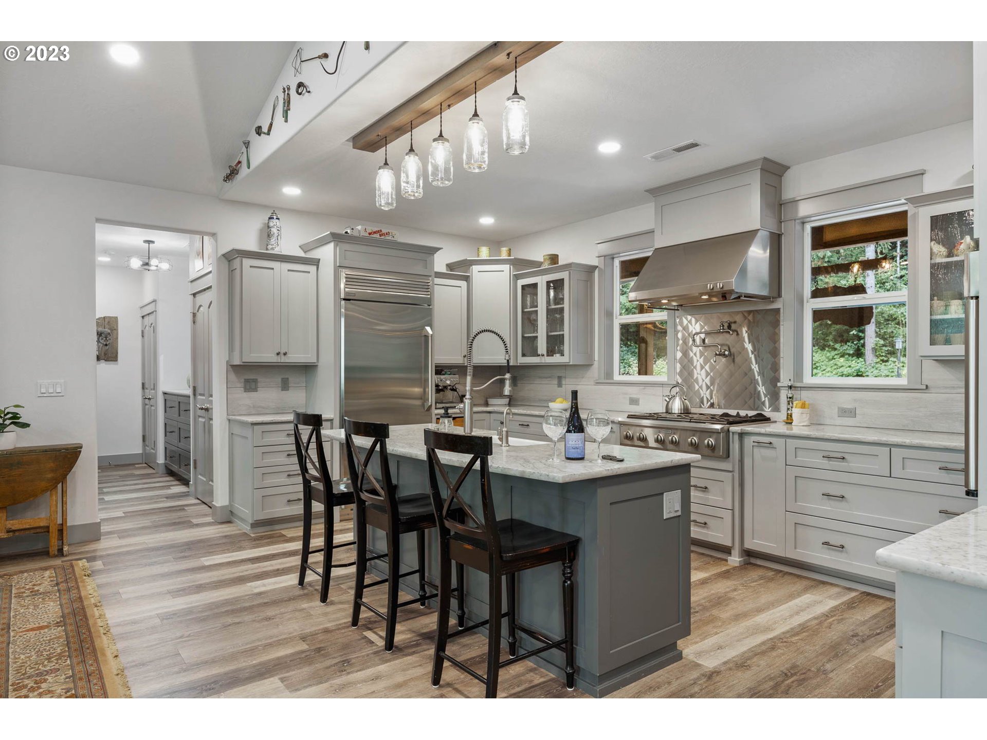 37693 Hills Creek Road Springfield, OR 97478 - Photo 12 of 48 a kitchen with stainless steel appliances kitchen island granite countertop a table chairs sink and cabinets