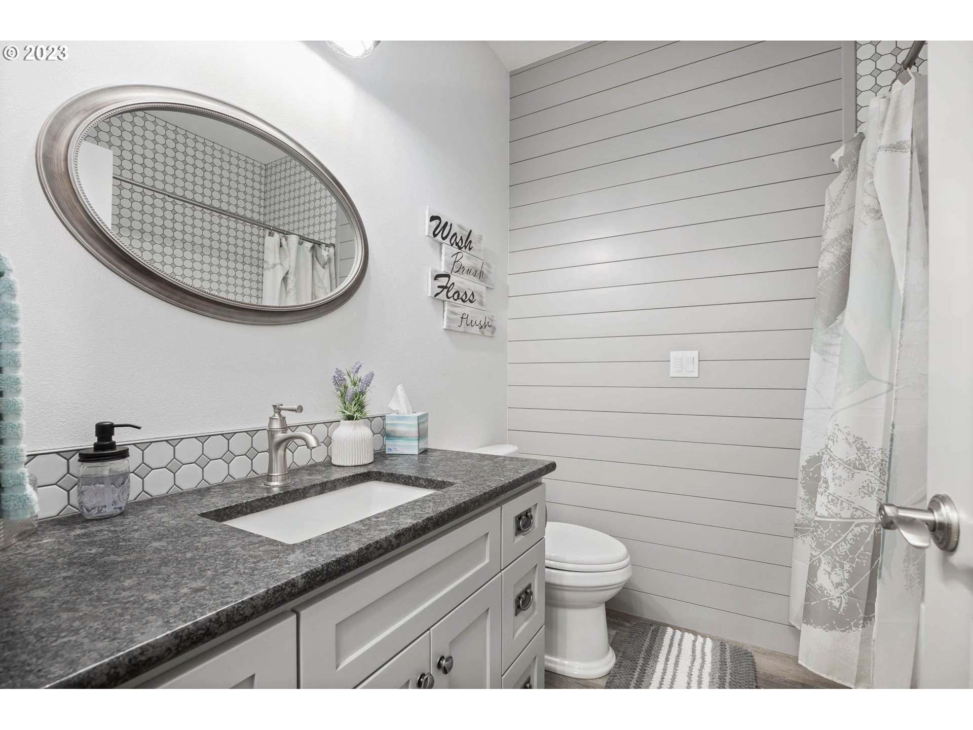 37693 Hills Creek Road Springfield, OR 97478 - Photo 20 of 48 a bathroom with a granite countertop toilet a sink and a mirror