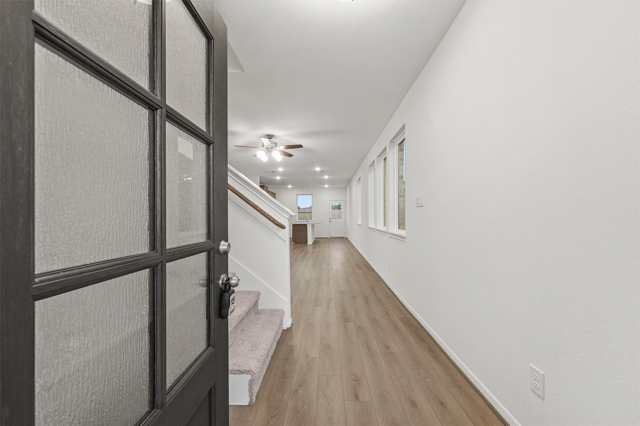 19111 Hazel Firs Court Magnolia, TX 77355 - Photo 4 of 34 a view of a hallway with wooden floor and staircase