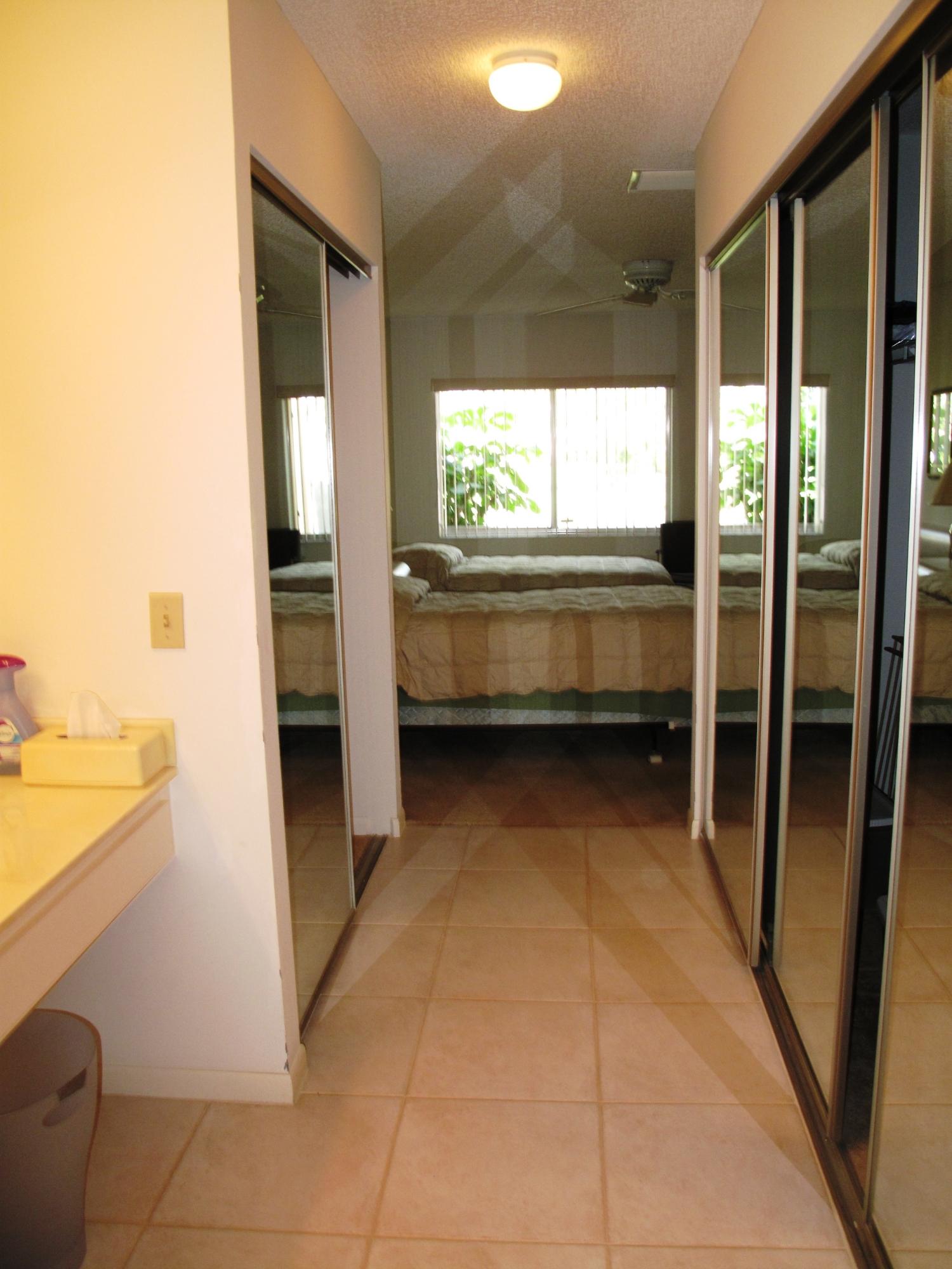 8152 Sweetbriar Way, Unit A Boca Raton, FL 33496 - Photo 31 of 44 walk in closet with view of master bedro