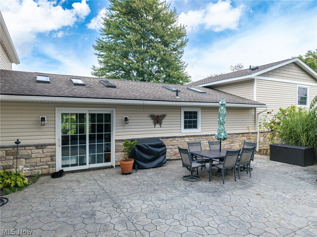 7996 Buffham Road Lodi, OH 44254 - Photo 7 of 40 Stamped concrete patio, sliding glass doors, skylights, stone-accented exterior, and siding
