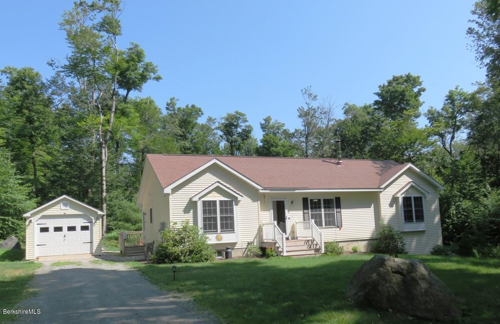714 Dimmock Road Otis, MA 01253 - Photo 1 of 14 a front view of a house with a garden and trees