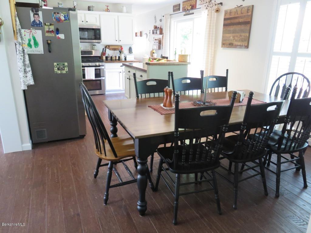 714 Dimmock Road Otis, MA 01253 - Photo 4 of 14 a view of a dining room with furniture and wooden floor