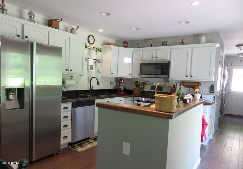 714 Dimmock Road Otis, MA 01253 - Photo 5 of 14 a kitchen with stainless steel appliances granite countertop a sink stove and refrigerator