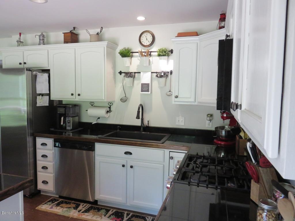 714 Dimmock Road Otis, MA 01253 - Photo 6 of 14 a kitchen with stainless steel appliances a stove a sink a refrigerator and a cabinets