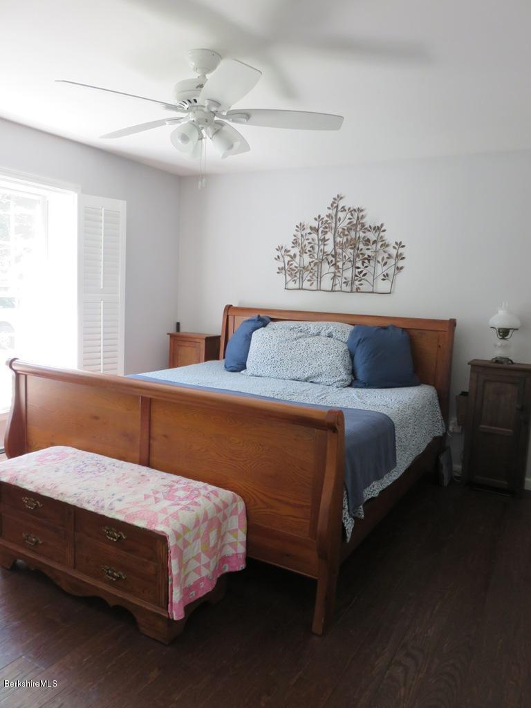 714 Dimmock Road Otis, MA 01253 - Photo 8 of 14 a bedroom with a bed painting on wall and a chandelier