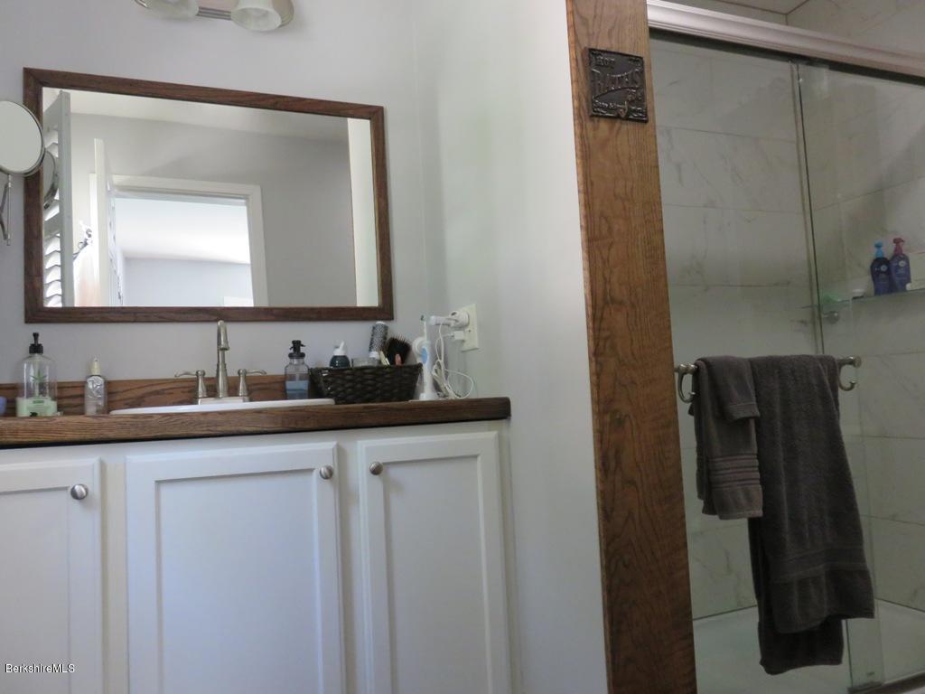 714 Dimmock Road Otis, MA 01253 - Photo 10 of 14 a bathroom with a double vanity sink and a mirror