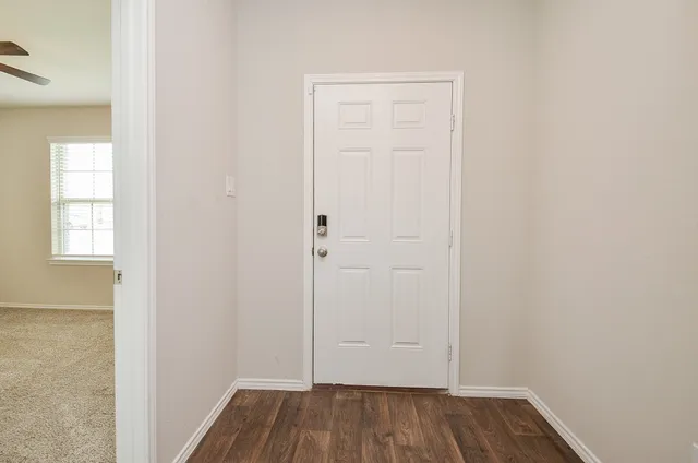 an empty room with wooden floor and closet