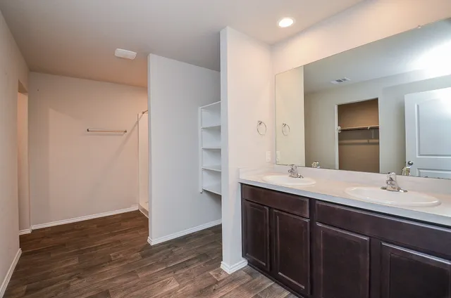 a bathroom with a double vanity sink and mirror