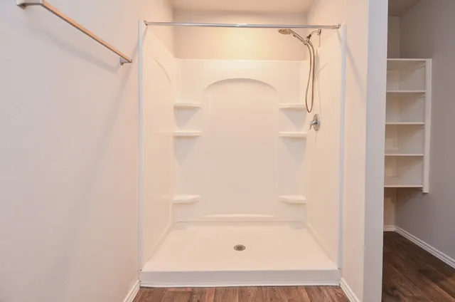 a bathroom with a glass shower door