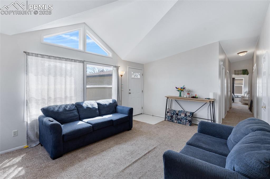 7659 Marmot Point Colorado Springs, CO 80922 - Photo 5 of 24 a living room with furniture and a large window