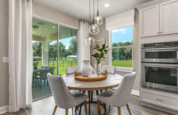 a view of a dining room with furniture window and wooden floor