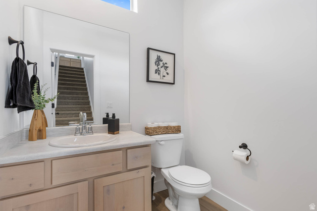 636 West Caroles Way, Unit 7 Tooele, UT 84074 - Photo 16 of 31 Bathroom featuring a light wood-finish vanity with a built-in sink, chrome faucet, and expansive wall mirror