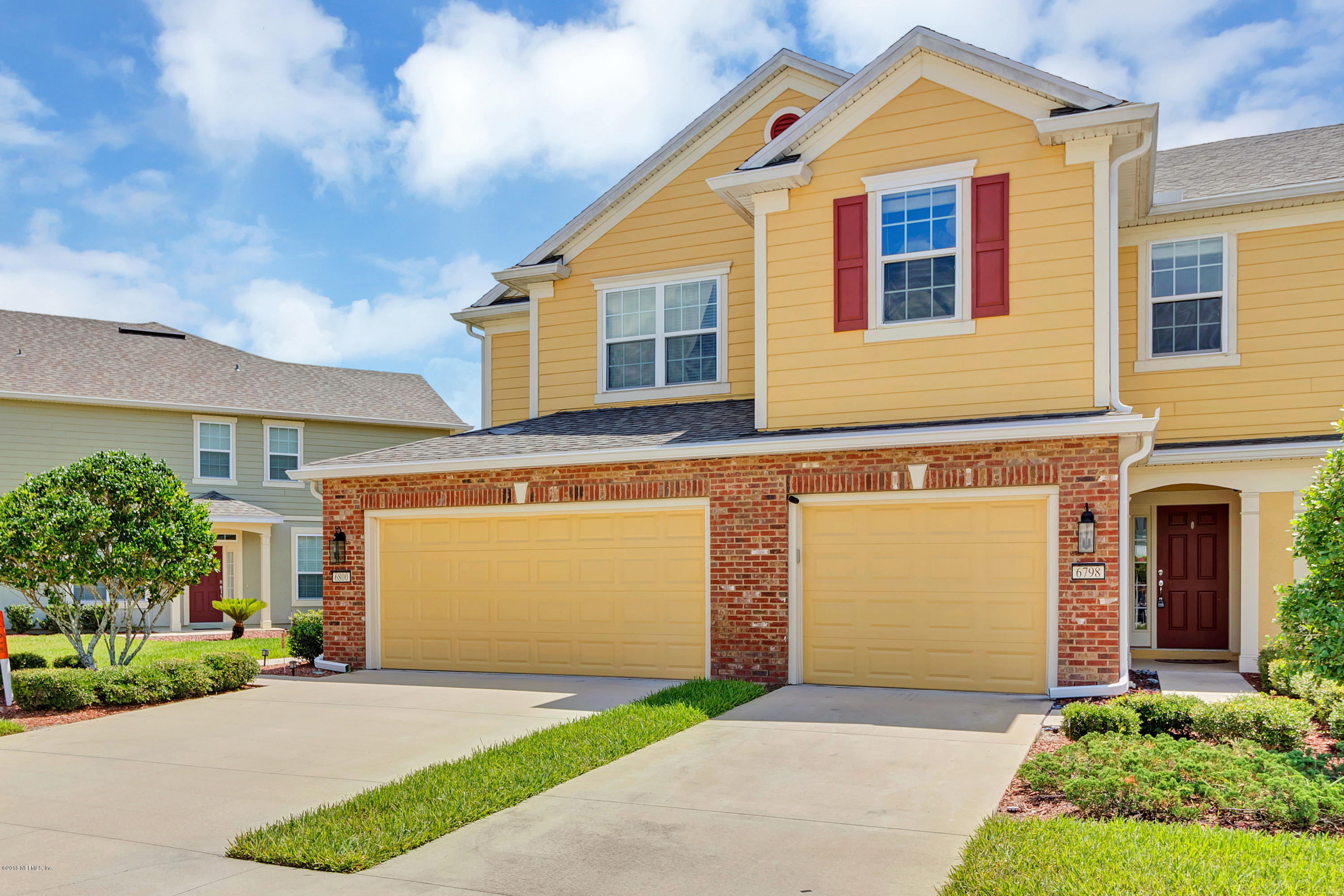 6798 Roundleaf Drive Jacksonville, FL 32258 - Photo 1 of 21 a front view of a house with a garden and garage