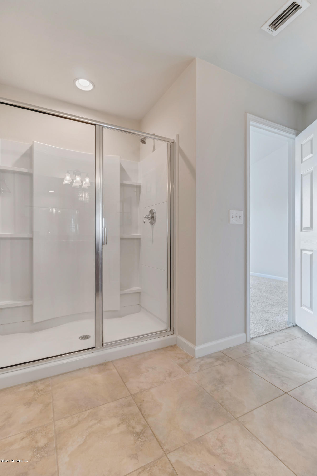 6798 Roundleaf Drive Jacksonville, FL 32258 - Photo 11 of 21 a bathroom with a glass shower door
