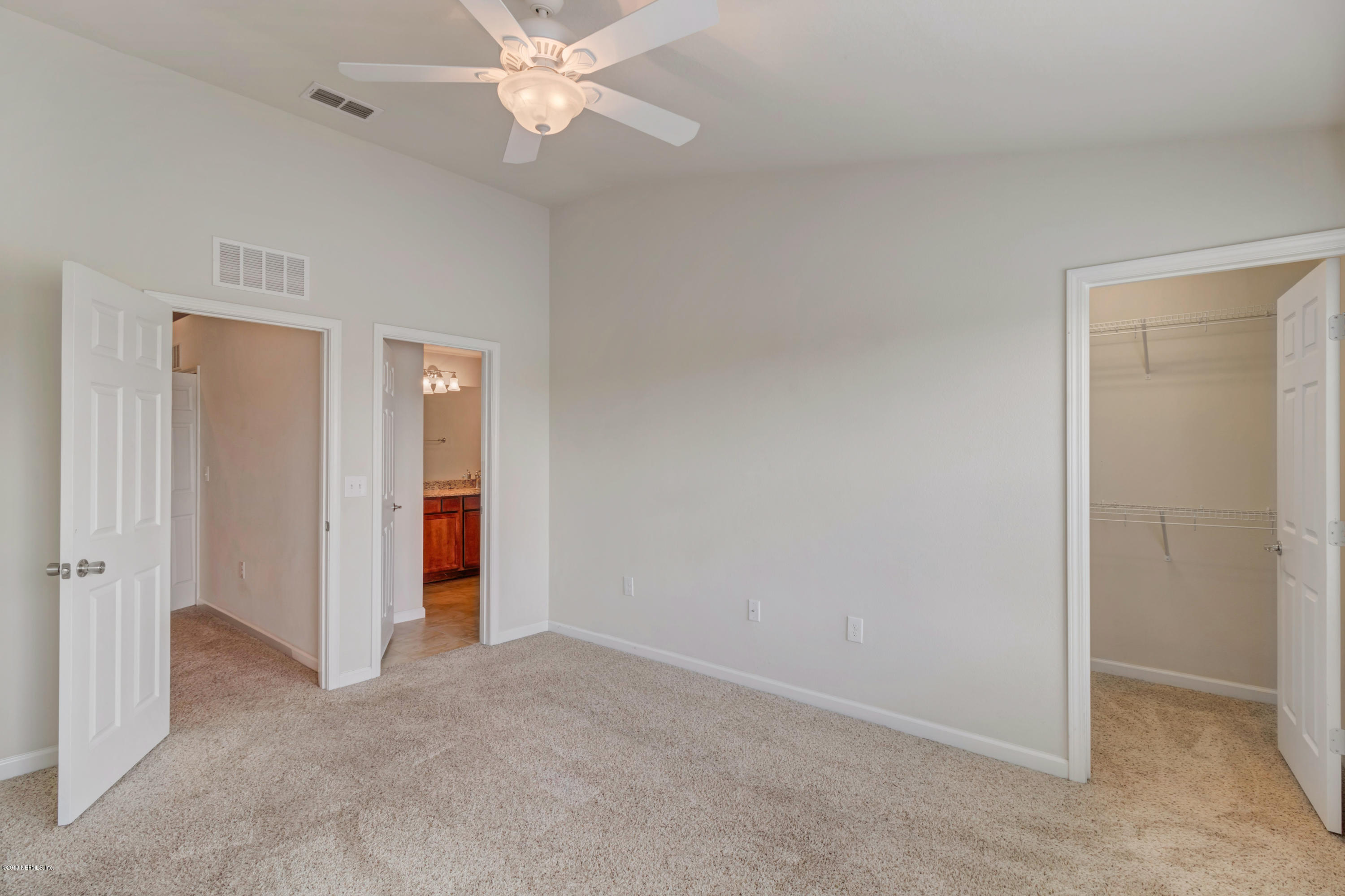 6798 Roundleaf Drive Jacksonville, FL 32258 - Photo 15 of 21 an empty room with closet and a chandelier fan