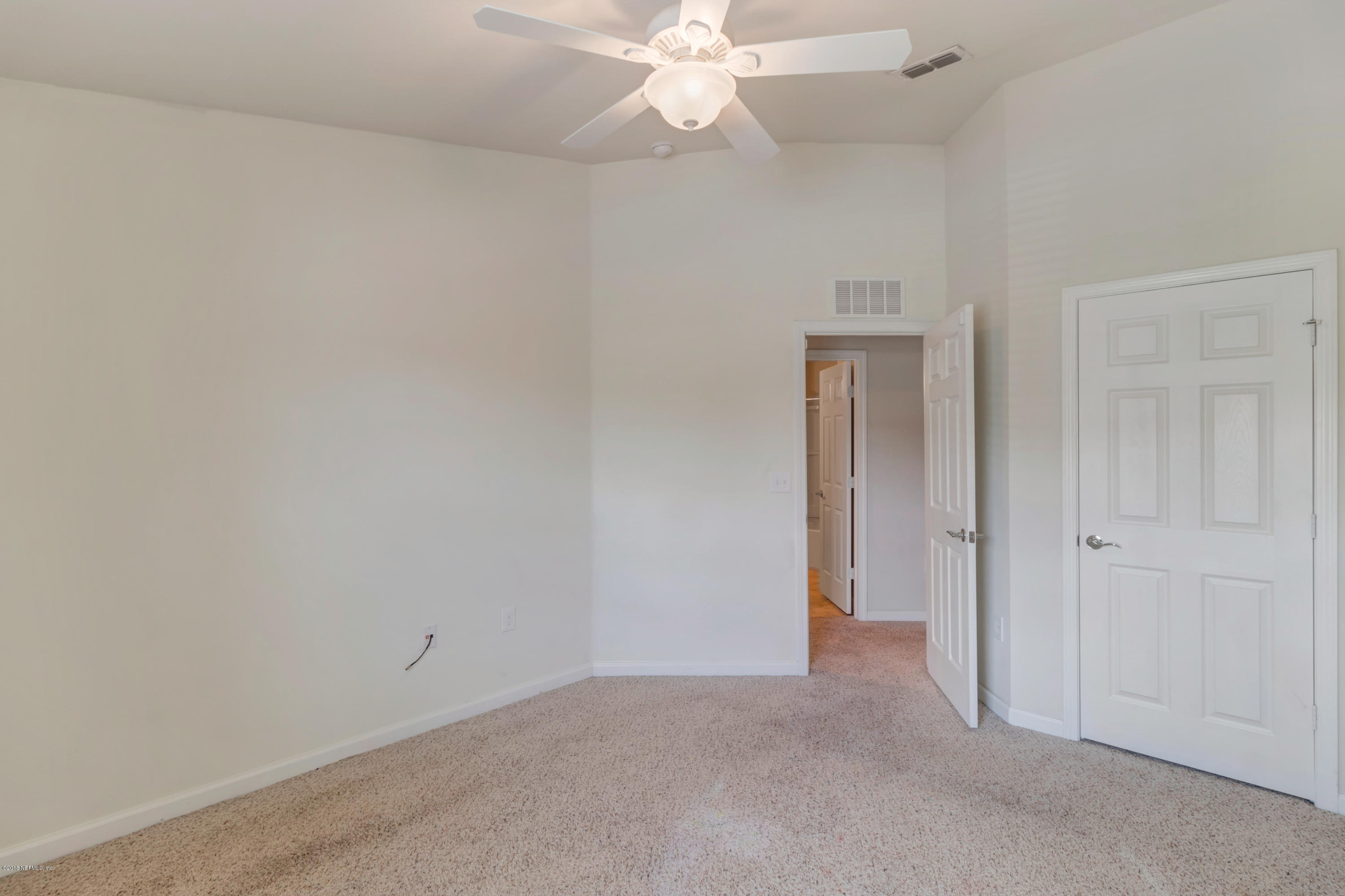 6798 Roundleaf Drive Jacksonville, FL 32258 - Photo 16 of 21 an empty room with closet and a chandelier fan