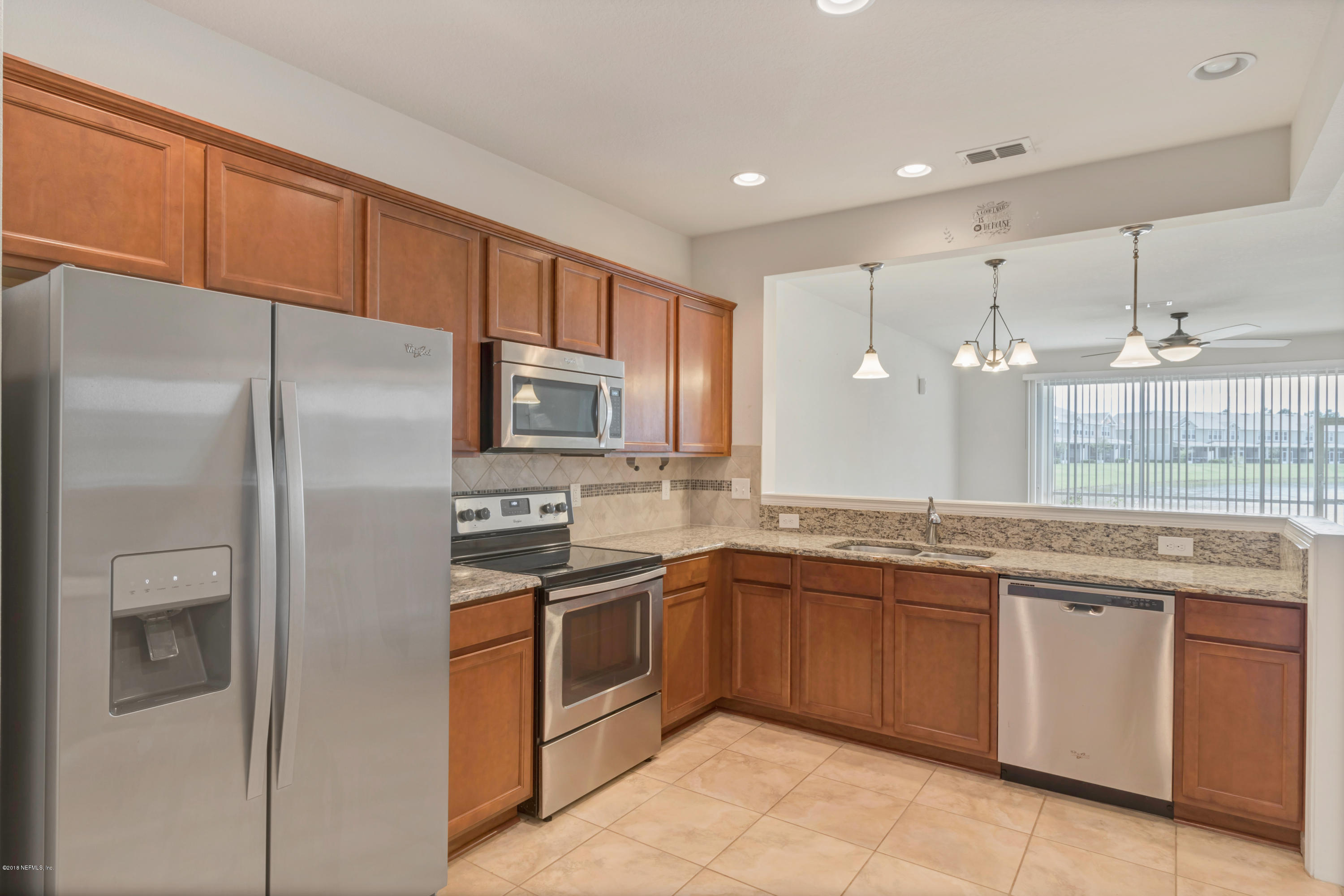 6798 Roundleaf Drive Jacksonville, FL 32258 - Photo 7 of 21 a kitchen with stainless steel appliances granite countertop a refrigerator and a sink