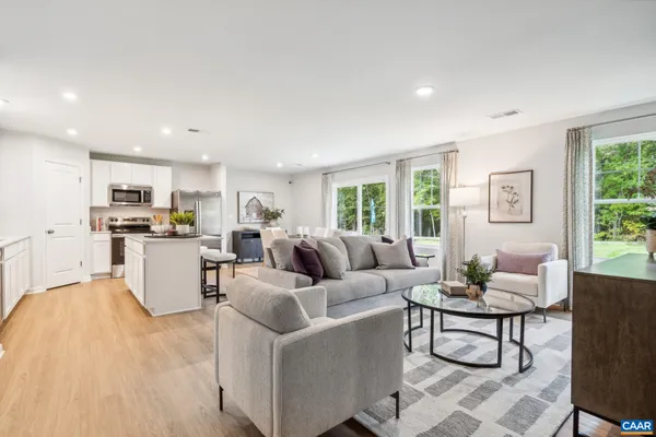 a living room with furniture and kitchen view