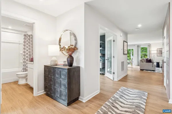 a living room with furniture a bathtub and a chandelier