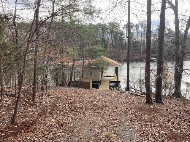 a view of a house with a yard and sitting area