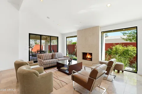 a living room with furniture fireplace and a large window