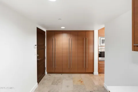 a large kitchen with stainless steel appliances kitchen island granite countertop a sink and cabinets