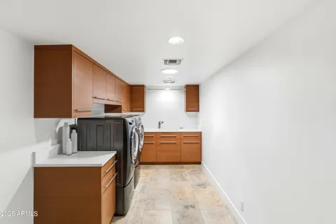 a kitchen with kitchen island cabinets and refrigerator