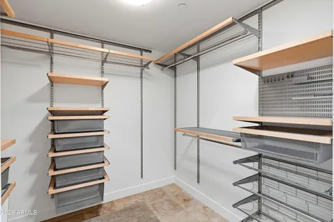a view of walk in closet with empty racks
