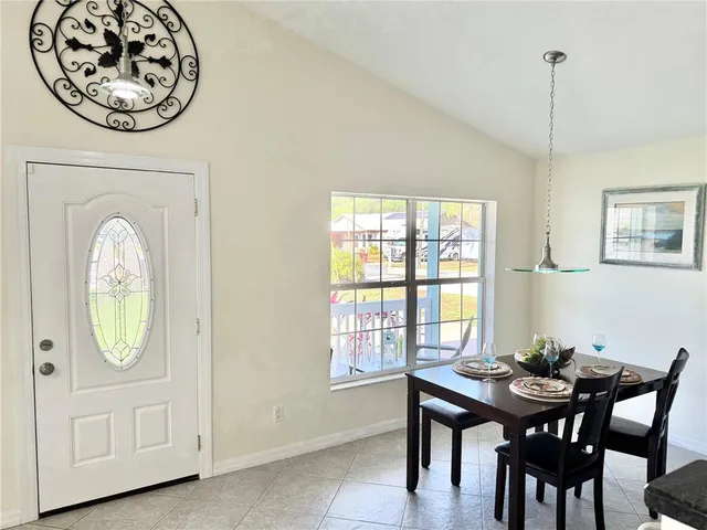 a kitchen with kitchen island granite countertop a table and chairs in it
