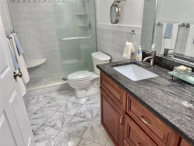 a view of a hallway with wooden floor and a potted plant