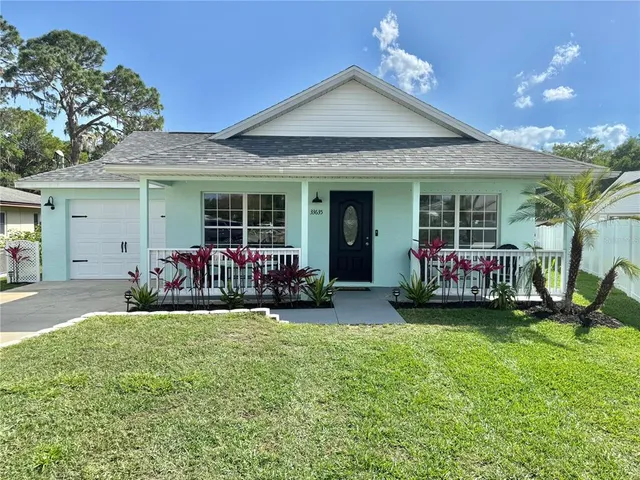 a view of a house with sitting area and garden