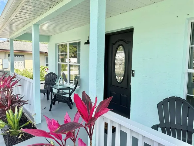 a view of a dining room with furniture and a window