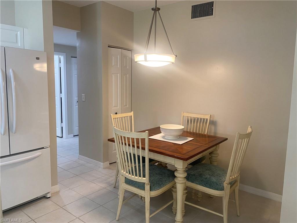 295 Waterside Circle, Unit 1102 Marco Island, FL 34145 - Photo 14 of 31 a view of a dining room with furniture