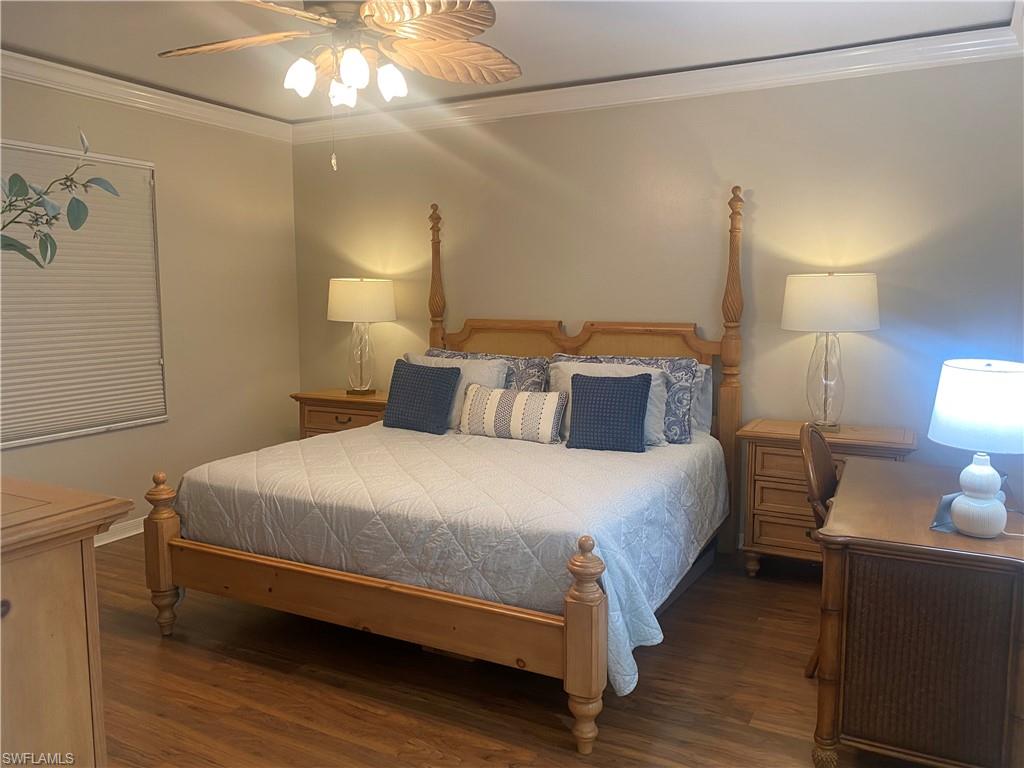 295 Waterside Circle, Unit 1102 Marco Island, FL 34145 - Photo 15 of 31 a bedroom with a bed and a lamp