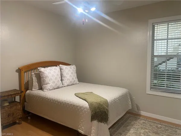 a bedroom with a bed and a window