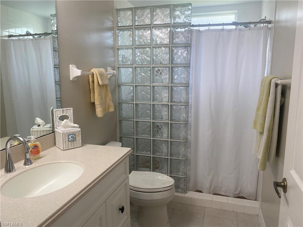 295 Waterside Circle, Unit 1102 Marco Island, FL 34145 - Photo 22 of 31 a bathroom with a sink toilet and shower