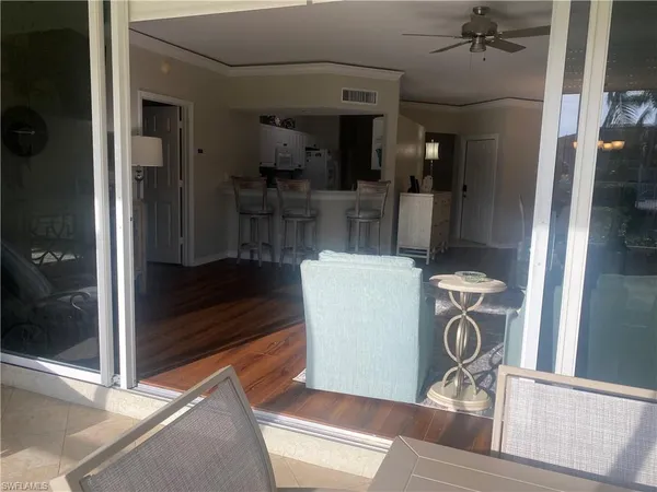 a view of a hallway with dining room and furniture