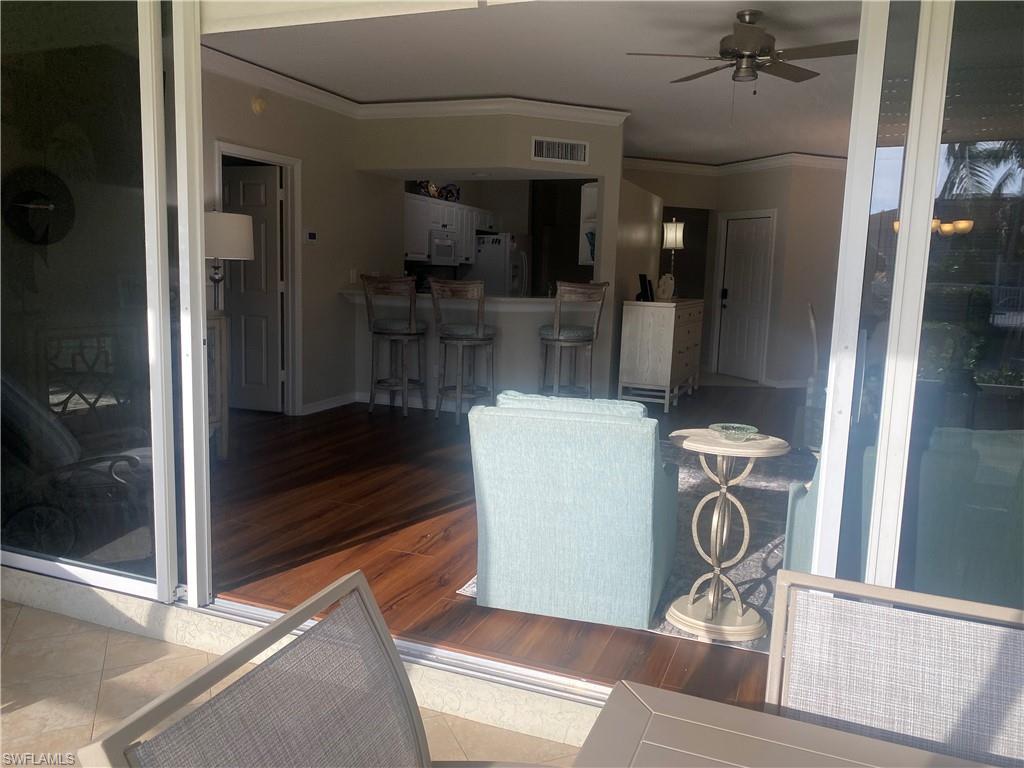 295 Waterside Circle, Unit 1102 Marco Island, FL 34145 - Photo 26 of 31 a view of a hallway with dining room and furniture